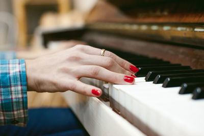 Close-up of woman playing piano