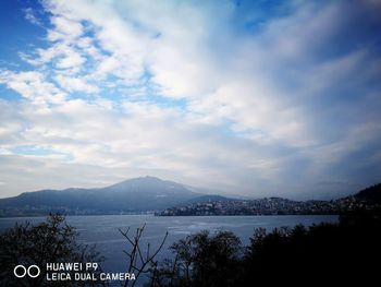 Scenic view of sea and mountains against sky