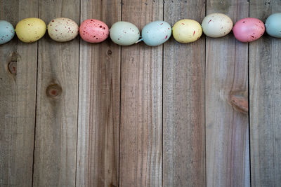 Close-up of multi colored eggs on wood