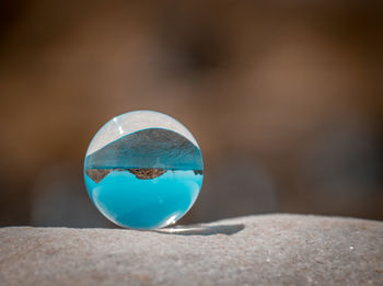 Close-up of blue glass on rock