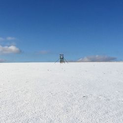 Scenic view of desert against blue sky