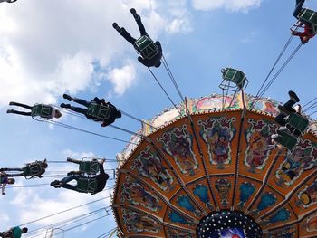 Low angle view of ferris wheel against sky