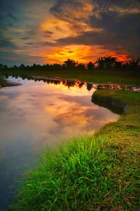 Scenic view of lake against sky during sunset