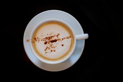 Directly above shot of coffee cup against black background