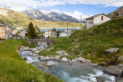 Scenic view of lake and houses against mountain