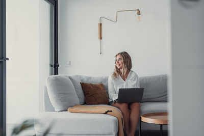 Young woman using digital tablet at home