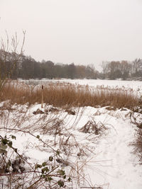 Frozen lake against clear sky during winter