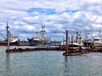 Boats moored at harbor
