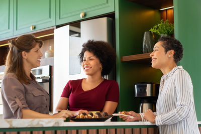 Smiling young woman standing in restaurant