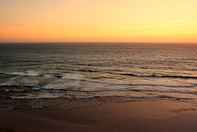 Scenic view of sea against romantic sky at sunset