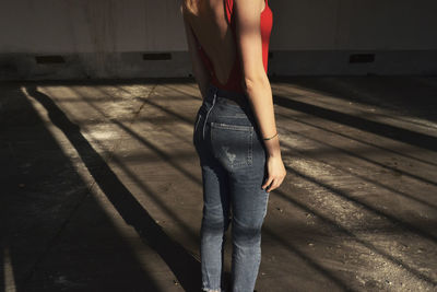 Low section of woman standing on tiled floor