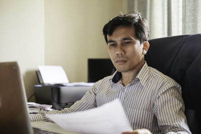 Close-up of businessman working at desk in office