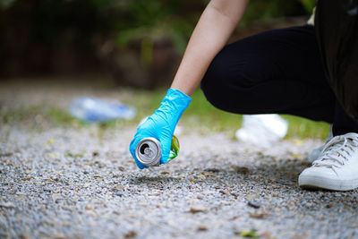 Low section of woman tying shoelace