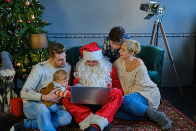 Full length of family with santa at home