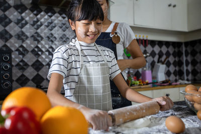 Cute girl preparing food at kitchen