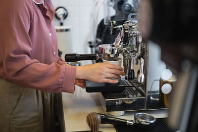 Midsection of woman working with coffee