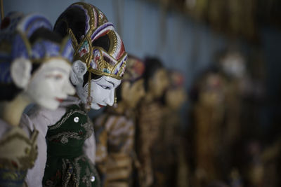 Close-up of colorful puppets at stall