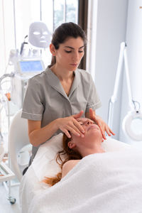 Female doctor examining patient at clinic