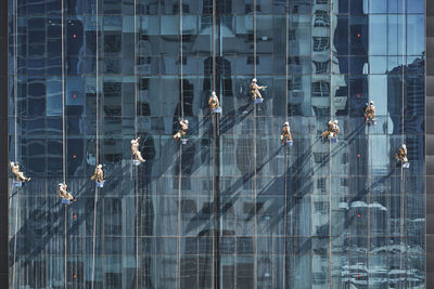 Men cleaning glass building