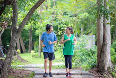 People walking on footpath in forest