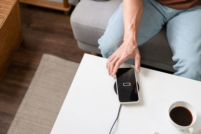 Midsection of woman using mobile phone