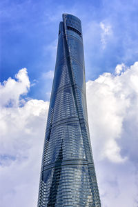 Low angle view of modern building against cloudy sky