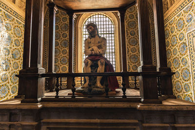 Low angle view of statue in temple against building