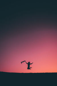 Low angle view of silhouette man against sky