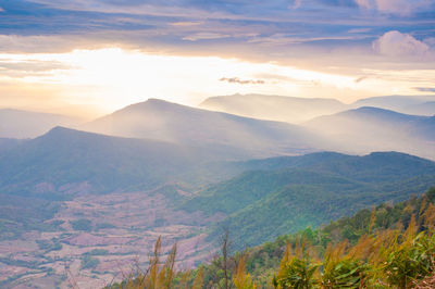 Scenic view of mountains against sky at sunset