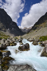 Scenic view of waterfall against sky