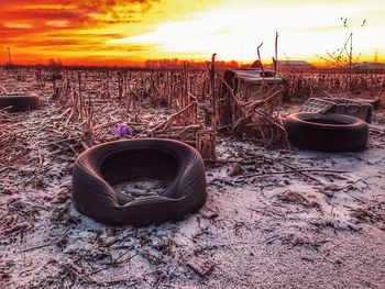 Close-up of sunglasses against sky at sunset