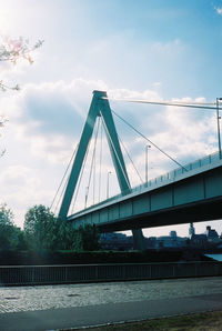 Low angle view of suspension bridge against sky