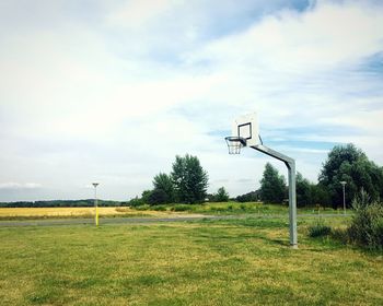 View of basketball hoop on field against sky