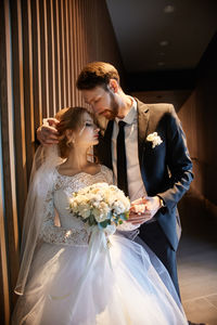 Affectionate couple standing together in corridor