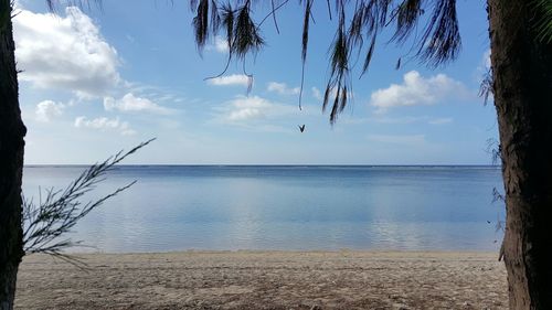 Scenic view of sea against cloudy sky