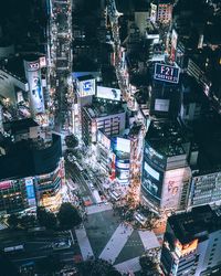 High angle view of illuminated city street and buildings at night
