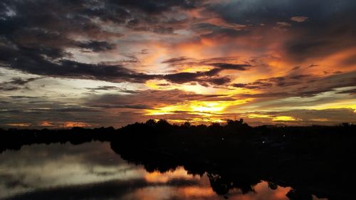 Scenic view of lake against orange sky