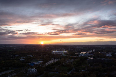 High angle view of illuminated cityscape against sky during sunset