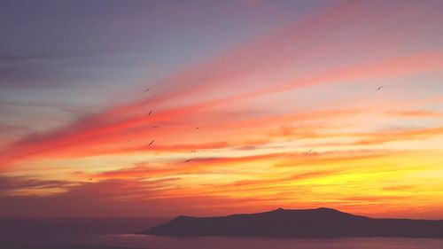 Scenic view of sea against romantic sky at sunset