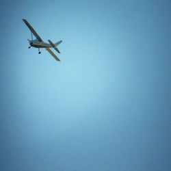 Low angle view of airplane flying in sky