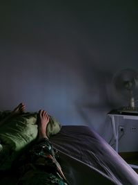 Woman sleeping on bed at home