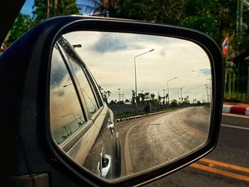 Reflection of road in side-view mirror of car