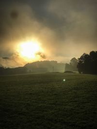 Scenic view of field against sky during sunset