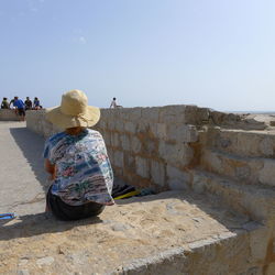 Full length of woman standing by railing
