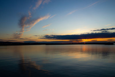 Scenic view of lake against romantic sky at sunset