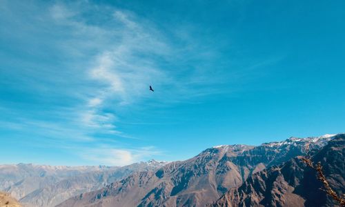 Low angle view of mountain against blue sky