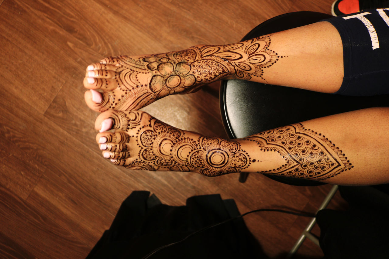 tattoo, adult, indoors, henna, one person, pattern, women, arm, henna tattoo, hand, human limb, human leg, limb, fashion, lifestyles, close-up, creativity, arts culture and entertainment, young adult, low section