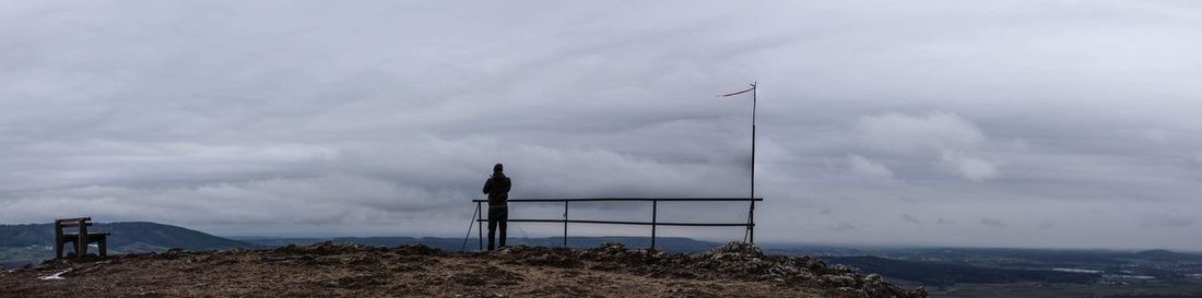 Windmill on mountain against sky
