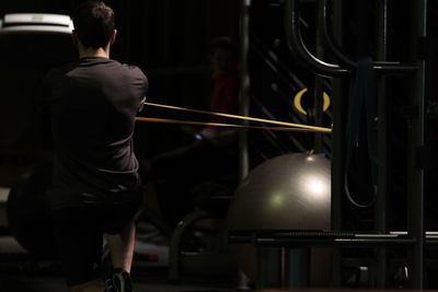 Rear view of man exercising in gym