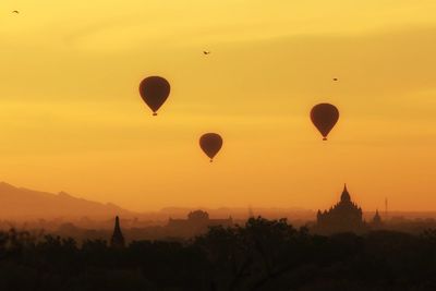 Hot air balloons in sky at sunset